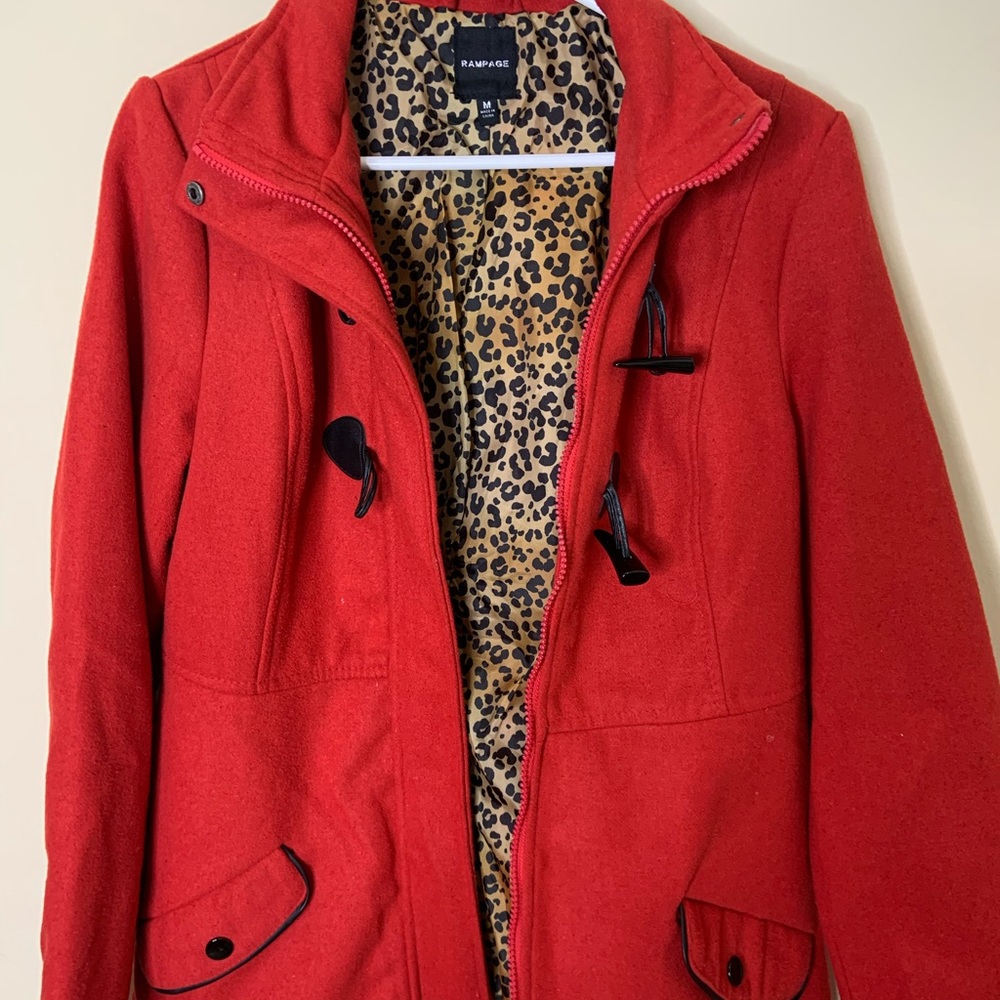 red jacket with cheetah inside and black details